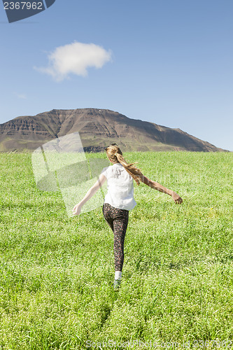 Image of Young girl running in the field