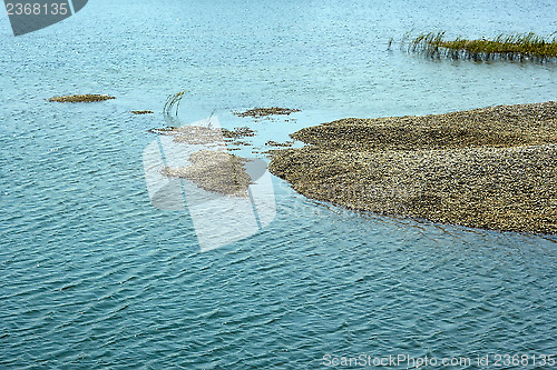 Image of Pebbles heap in a marine lagoon 