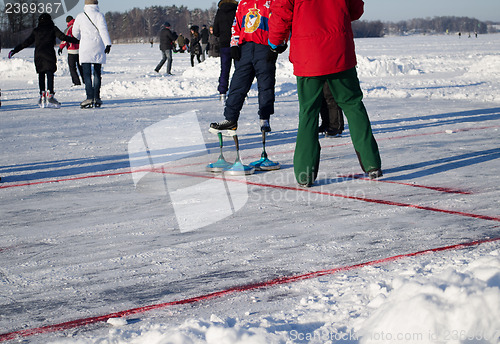 Image of eisstock curling toys and people play winter game 