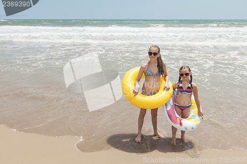 Image of Two girls playing on the beach