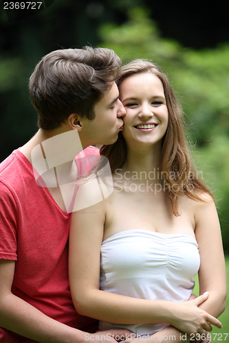 Image of Loving young man kissing his girlfriend