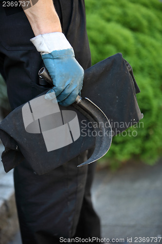 Image of Chimney sweep holding a scraping tool