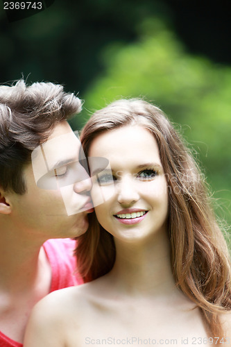 Image of Young man kissing his girlfriend