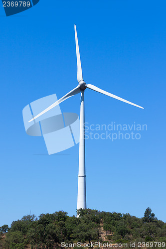 Image of Wind electric generator against blue sky