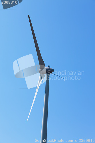 Image of Wind electric generator against blue sky