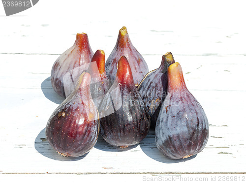 Image of Fresh fig fruits on white wooden background