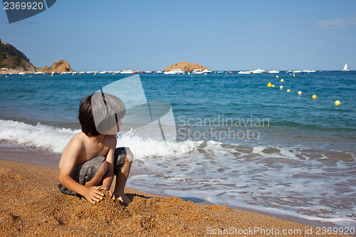 Image of boy on the shore of  sea