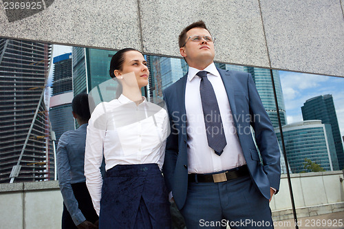 Image of young businessmen on the background of office buildings