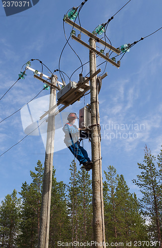 Image of Electrician perform maintenance on the transmission towers reclo
