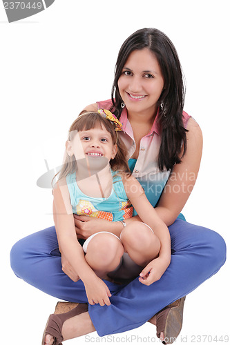 Image of mother and daughter sitting on the floor and hugging each other 