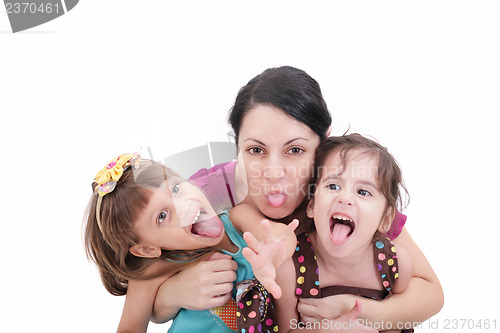 Image of Mother and two daughter pulling funny faces at camera