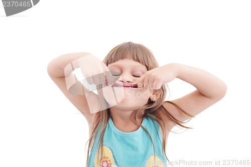 Image of Little girl making funny face, isolated on white