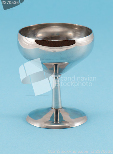 Image of retro grunge wine glass goblet on blue background 