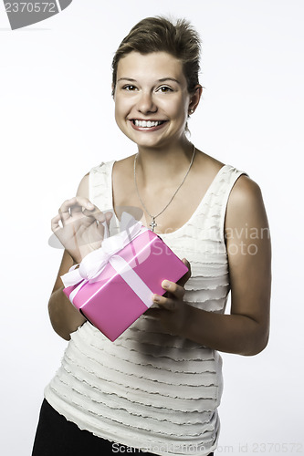 Image of Pretty young girl opens a present