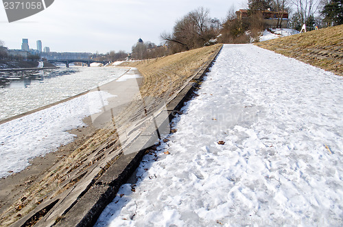 Image of frosted walking trail along river cold winter day 