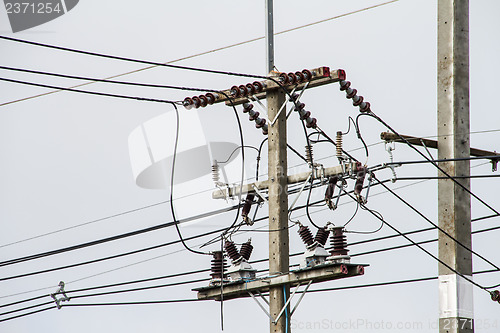 Image of Concrete pole with power lines and insulators.