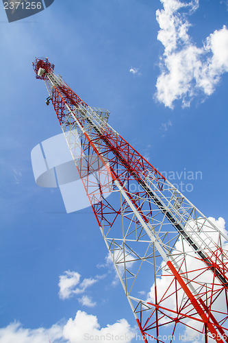 Image of Telecommunications tower with blue sky and cloud