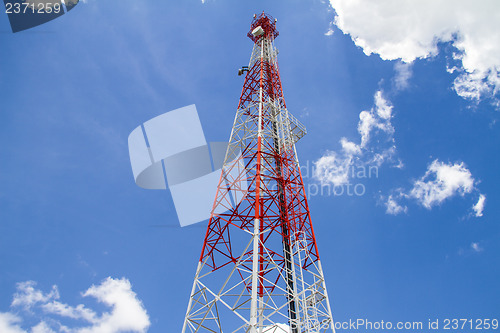 Image of Telecommunications tower with blue sky and cloud