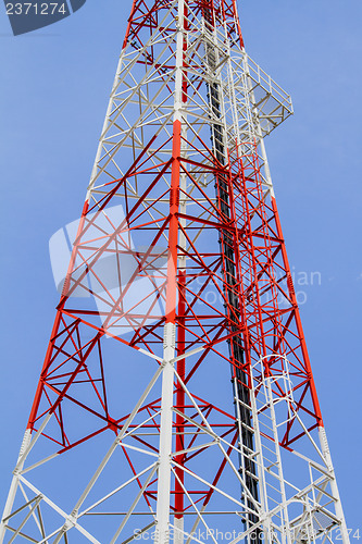 Image of Telecommunications tower with blue sky and cloud