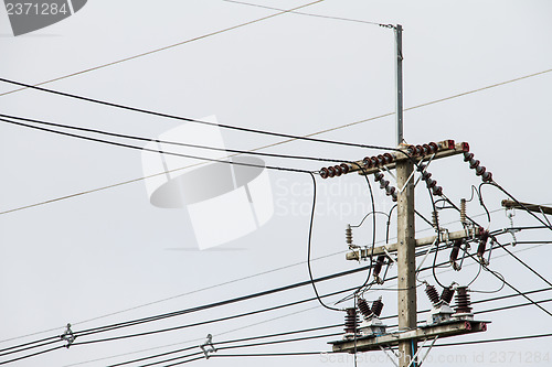 Image of Concrete pole with power lines and insulators.