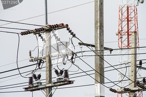 Image of Concrete pole with power lines and insulators.