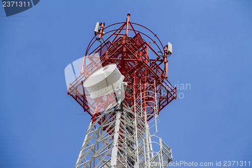 Image of Telecommunications tower with blue sky and cloud