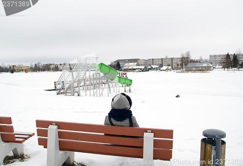 Image of woman sit bench water cascade playground winter 