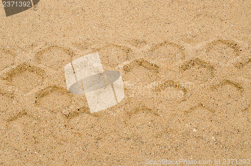 Image of heavy machine track mark remain sand background 