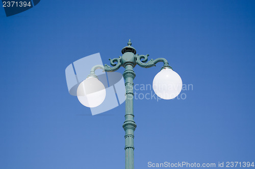 Image of vintage light pole double twin glass lamp blue sky 