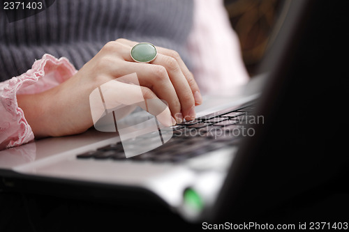 Image of Young woman working on laptop