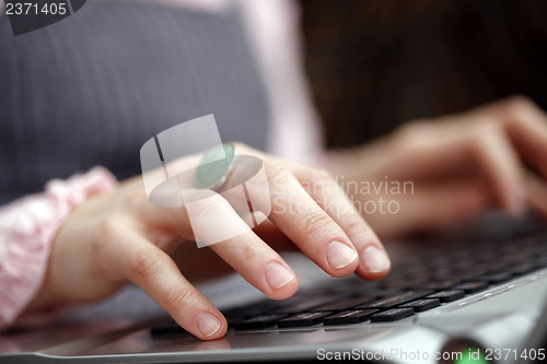 Image of Young woman working on laptop
