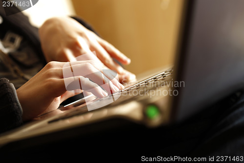 Image of Young woman working on laptop