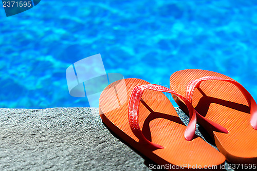 Image of sandals by a pool