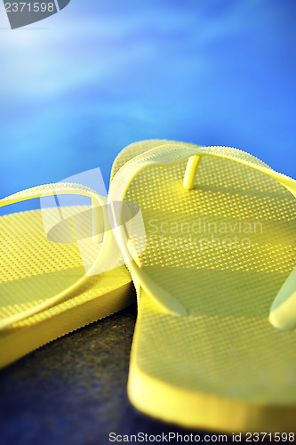 Image of sandals by a pool