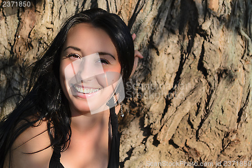 Image of The girl near a tree trunk