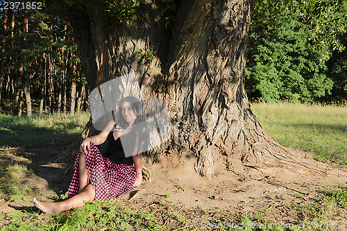 Image of A girl under the tree