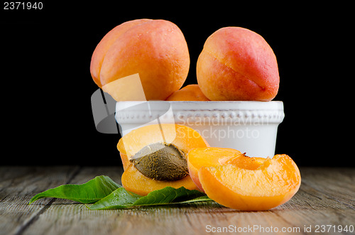 Image of Apricots on wooden table.