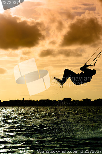 Image of Silhouette of a kitesurfer flying