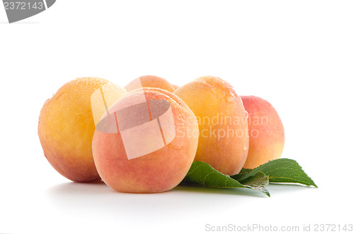 Image of Sweet peaches with leafs