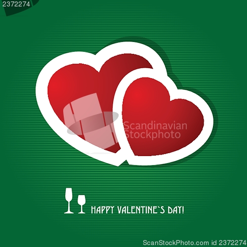 Image of Two red hearts on dark green background. Valentine`s card.
