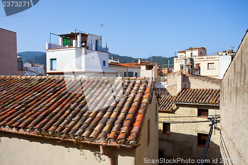 Image of red tiles on the roof of an old house