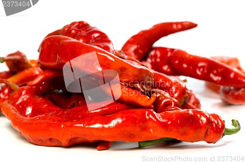 Image of Red chili peppers with water drops on white background