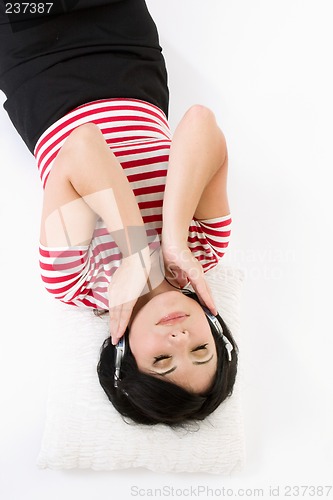 Image of Woman laying down listening to music