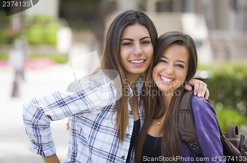 Image of Mixed Race Female Students Carrying Backpacks on School Campus