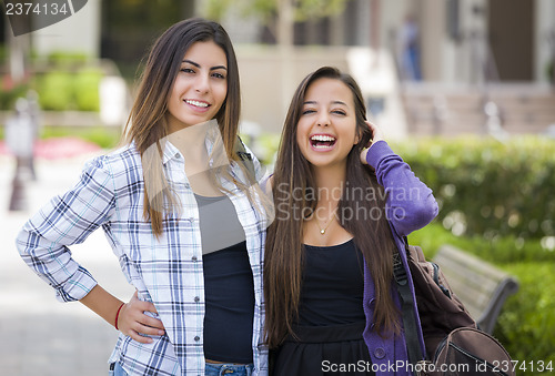 Image of Mixed Race Female Students Carrying Backpacks on School Campus