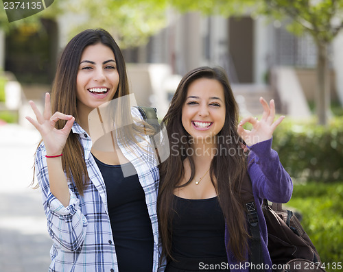 Image of Mixed Race Female Students on School Campus With Okay Sign