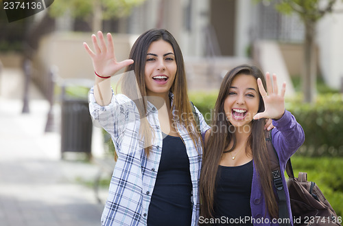 Image of Mixed Race Female Students Waving Carrying Backpacks on School C