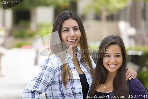 Image of Mixed Race Female Students Carrying Backpacks on School Campus