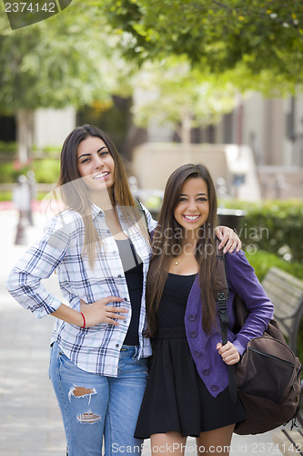 Image of Mixed Race Female Students Carrying Backpacks on School Campus