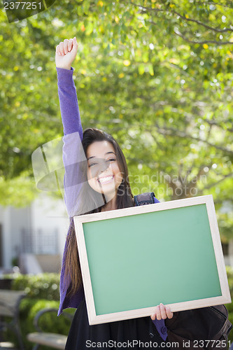 Image of Excited Mixed Race Female Student Holding Blank Chalkboard